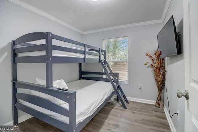 bedroom featuring hardwood / wood-style flooring and ornamental molding