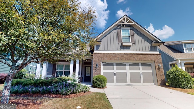 view of front facade with brick siding, board and batten siding, driveway, and a garage