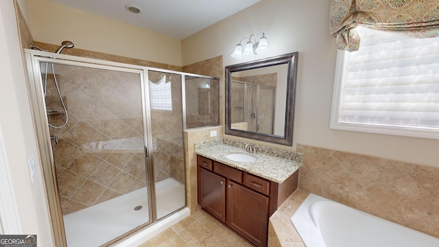 bathroom with tile patterned floors, a garden tub, vanity, and a shower stall