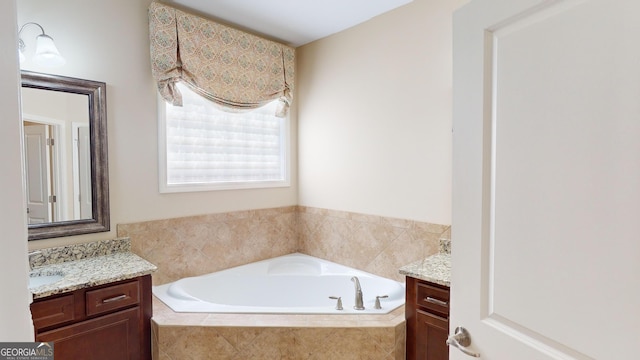 bathroom with a bath and vanity