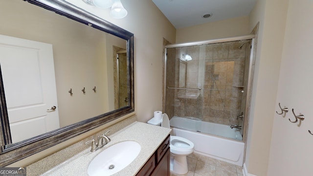 full bathroom with tile patterned floors, combined bath / shower with glass door, toilet, and vanity