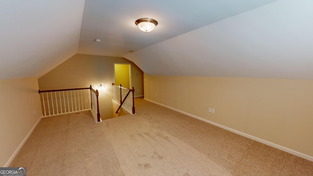 additional living space featuring lofted ceiling, carpet flooring, and baseboards