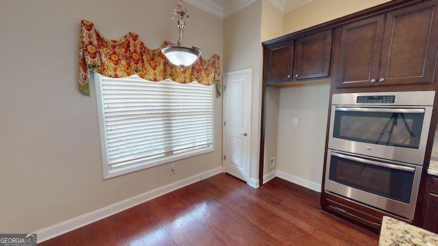 kitchen with dark brown cabinets, dark wood-type flooring, baseboards, crown molding, and double oven