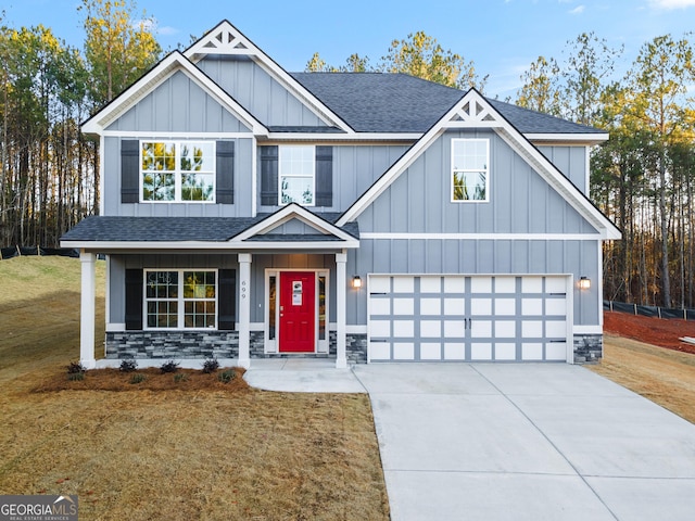 craftsman house featuring a garage and a front yard