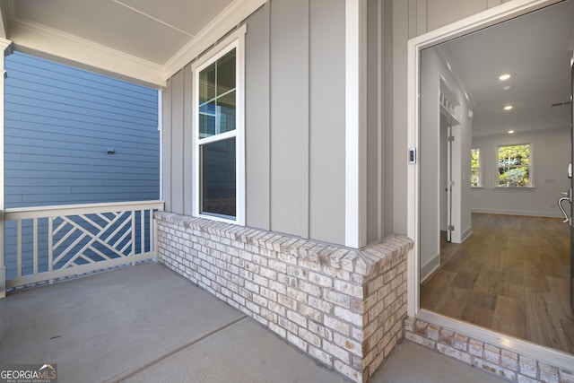 view of exterior entry featuring covered porch