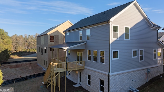 rear view of property with a wooden deck