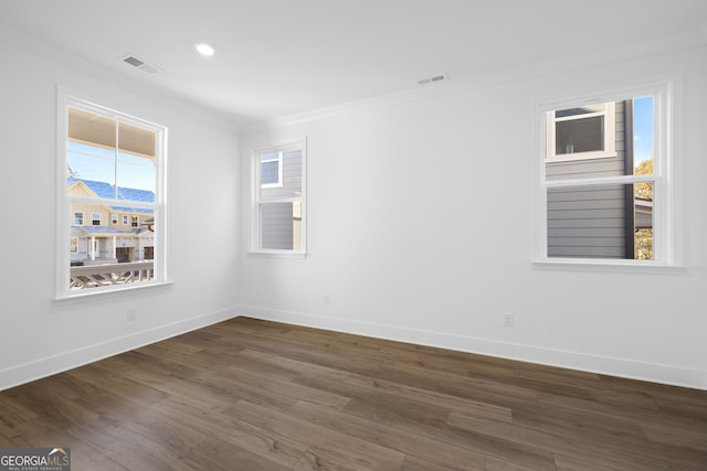 unfurnished room with crown molding and dark hardwood / wood-style flooring