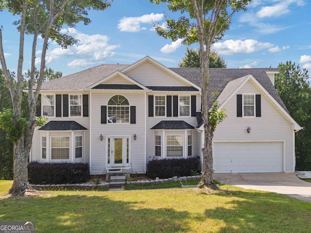 view of front of home featuring a garage and a front lawn