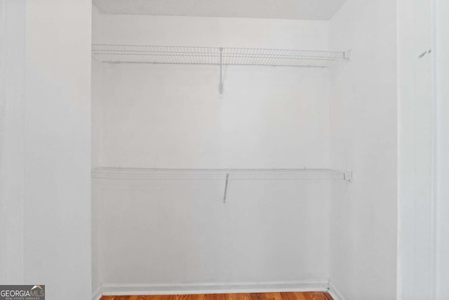 spacious closet with light hardwood / wood-style floors