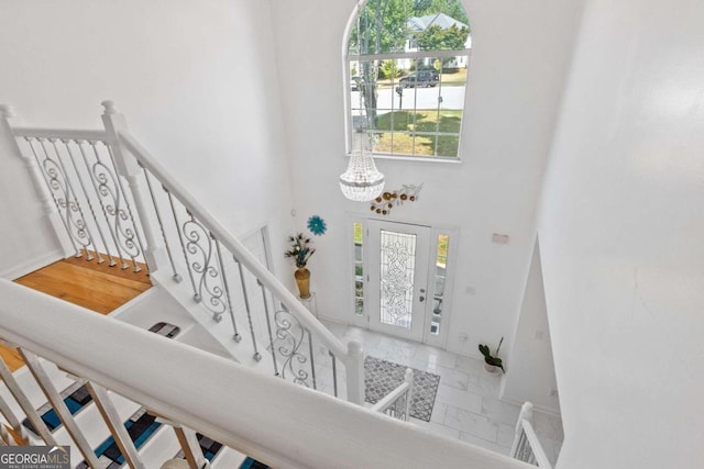 entrance foyer featuring a chandelier and a towering ceiling