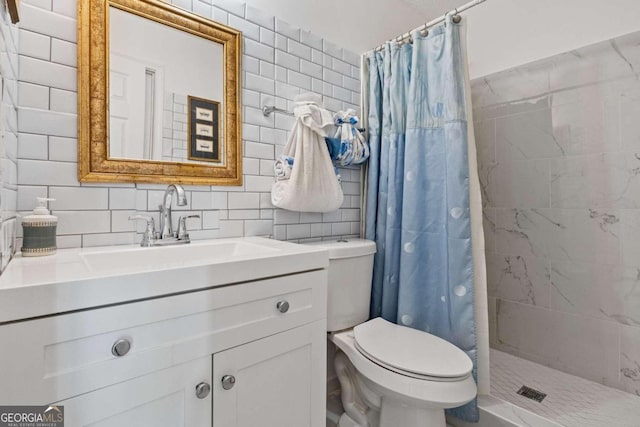 bathroom featuring tile walls, a shower with curtain, toilet, and vanity