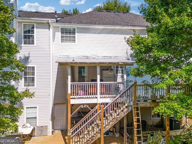 back of house with a deck and central air condition unit