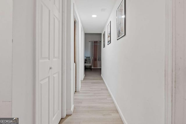 hallway with light wood-type flooring