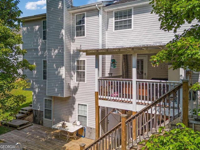 back of house with a wooden deck