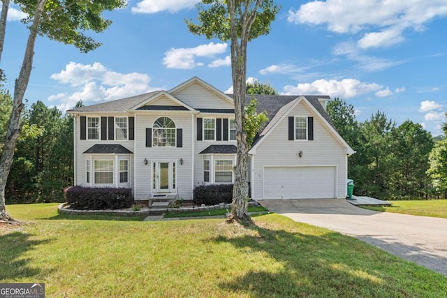 view of front of property featuring a front yard and a garage