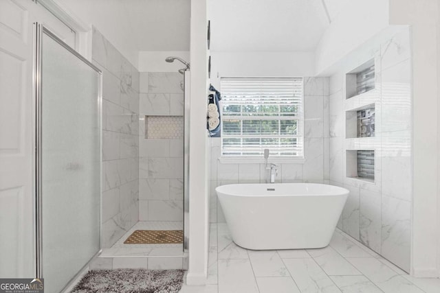 bathroom featuring tile walls and independent shower and bath