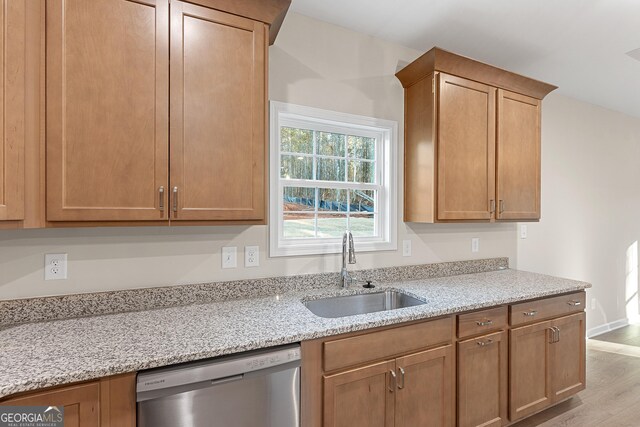 707 Jasmine Dr, Macon, GA 31211 - kitchen with a sink, dishwasher, light stone countertops, and wood finished floors