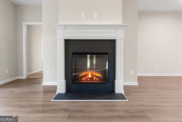 707 Jasmine Dr, Macon, GA 31211 - detailed view of a fireplace with flush hearth, wood finished floors, and baseboards