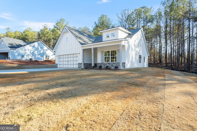 707 Jasmine Dr, Macon, GA 31211 - view of front of property with a garage, stone siding, board and batten siding, and a front yard
