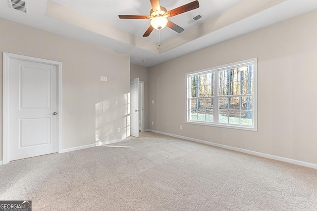 707 Jasmine Dr, Macon, GA 31211 - unfurnished bedroom with carpet floors, baseboards, a raised ceiling, and ceiling fan
