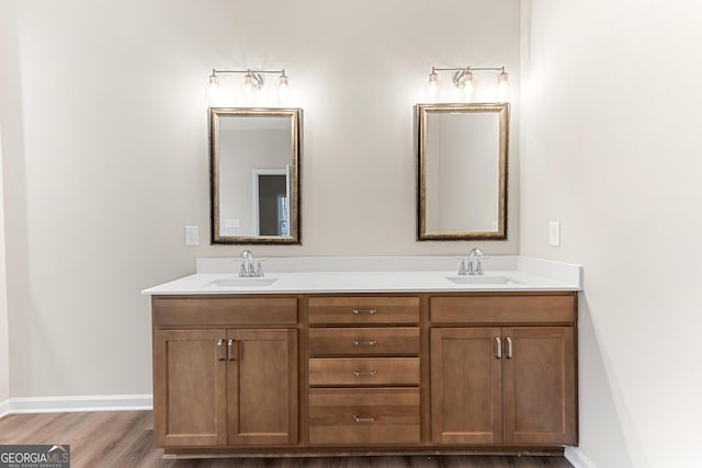707 Jasmine Dr, Macon, GA 31211 - bathroom with wood finished floors, double vanity, and baseboards