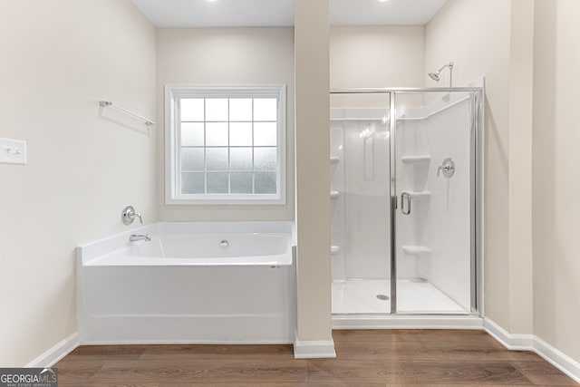 707 Jasmine Dr, Macon, GA 31211 - full bath featuring wood finished floors, a stall shower, a bath, and baseboards
