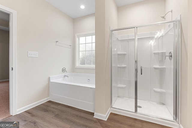 707 Jasmine Dr, Macon, GA 31211 - full bathroom featuring wood finished floors, a shower stall, and baseboards