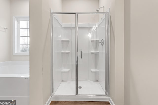 707 Jasmine Dr, Macon, GA 31211 - bathroom featuring a shower stall, a bath, and baseboards