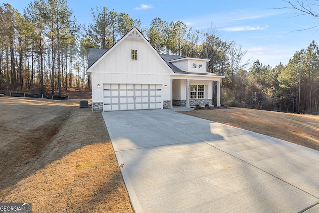 707 Jasmine Dr, Macon, GA 31211 - modern farmhouse with stone siding, board and batten siding, driveway, and covered porch