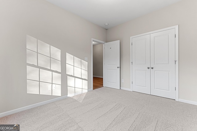 707 Jasmine Dr, Macon, GA 31211 - unfurnished bedroom with carpet flooring, baseboards, and a closet