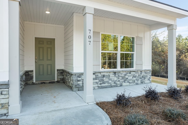 707 Jasmine Dr, Macon, GA 31211 - doorway to property with stone siding, a porch, and board and batten siding