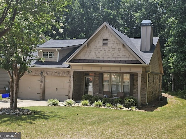 view of front of home with a garage and a front lawn