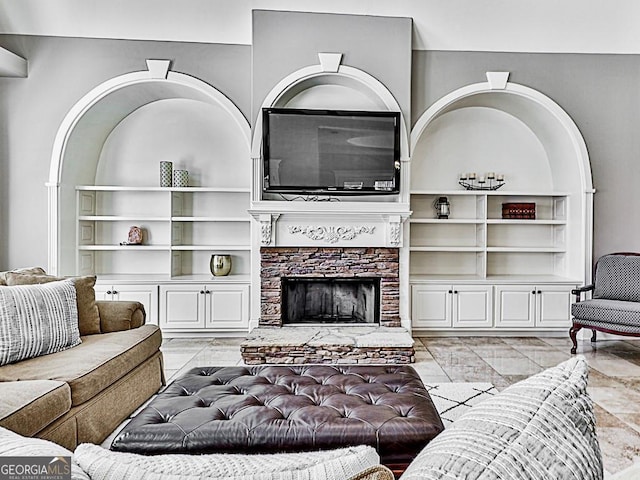 living room with a stone fireplace