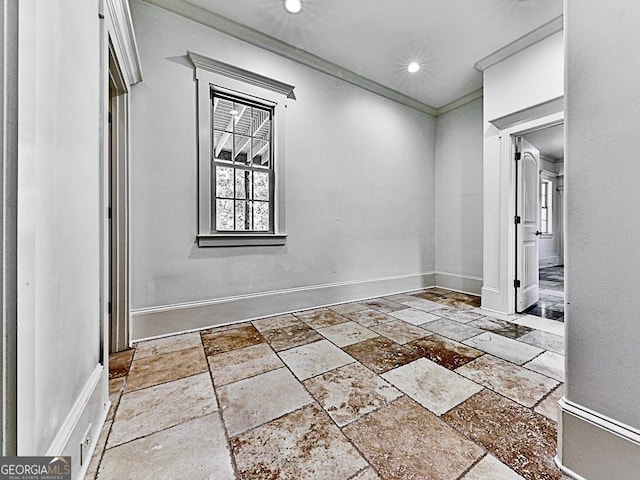 hallway with stone tile flooring, ornamental molding, baseboards, and recessed lighting