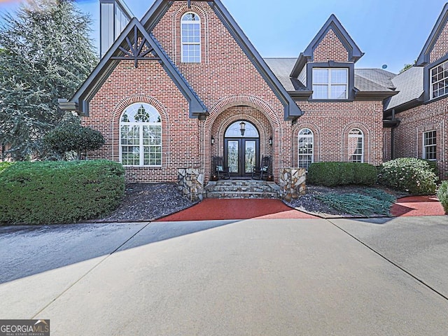 view of front of house featuring french doors and brick siding
