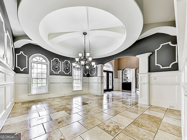 entrance foyer featuring an inviting chandelier and a tray ceiling