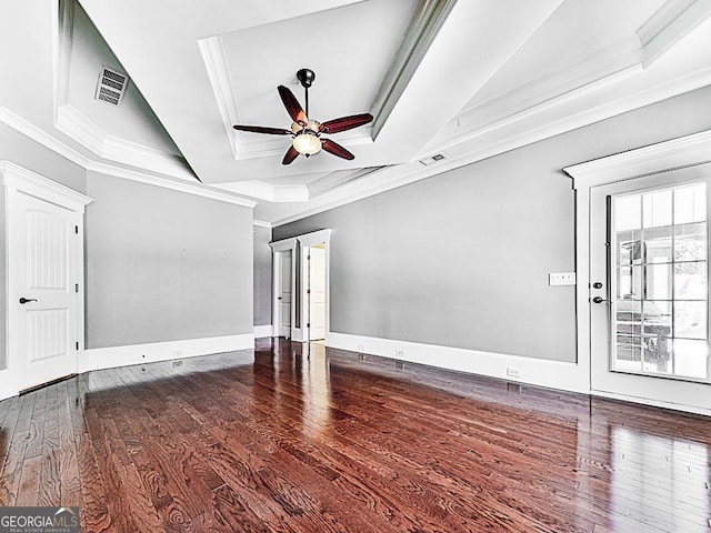 spare room with hardwood / wood-style floors, ceiling fan, a tray ceiling, and ornamental molding