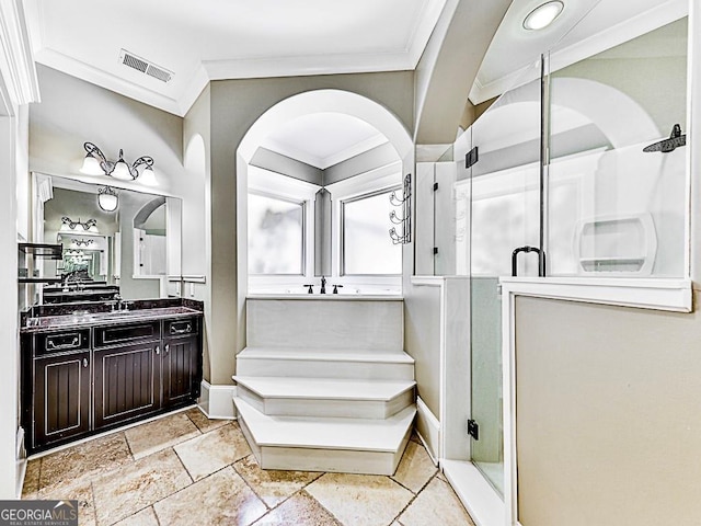 bathroom featuring crown molding, vanity, and a shower with door