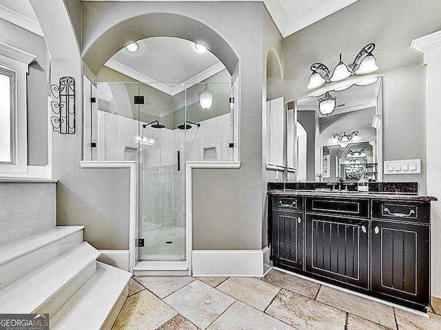 full bathroom with crown molding, a stall shower, vanity, baseboards, and stone tile flooring