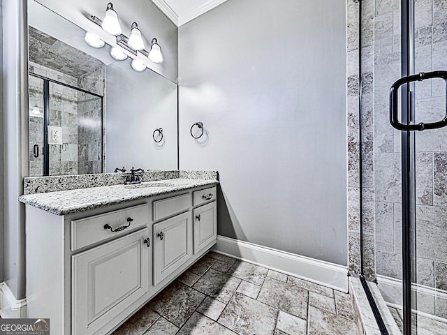 full bath featuring baseboards, ornamental molding, a stall shower, vanity, and stone tile flooring