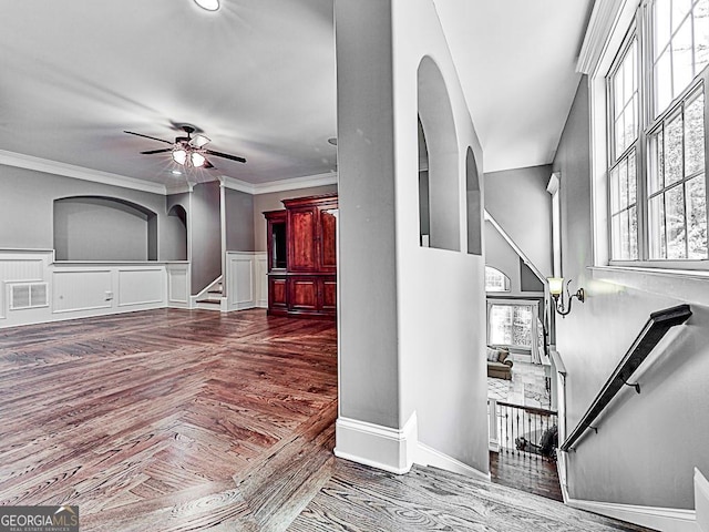 foyer entrance featuring ceiling fan and ornamental molding