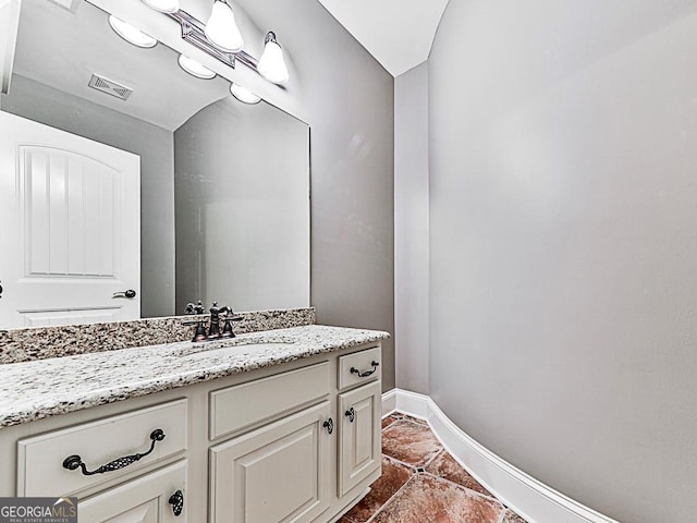 bathroom featuring baseboards, vanity, and tile patterned flooring