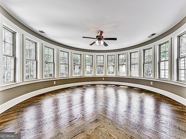 spare room with a ceiling fan and baseboards