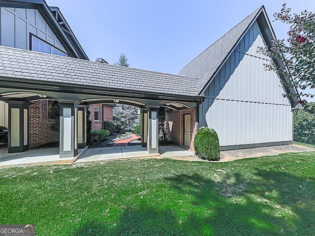 rear view of property featuring a yard