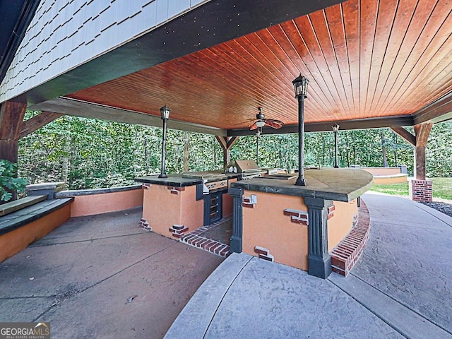 view of patio / terrace featuring a grill, an outdoor kitchen, and ceiling fan