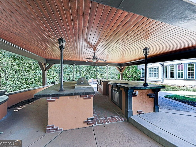 view of patio / terrace with exterior kitchen, ceiling fan, and area for grilling