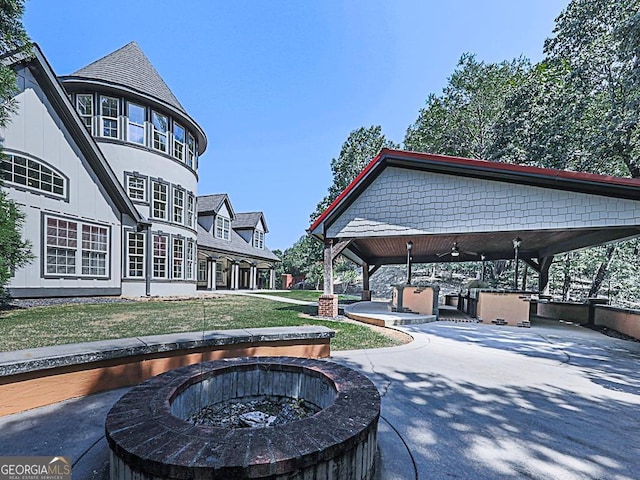 view of patio featuring an outdoor fire pit, ceiling fan, and a gazebo