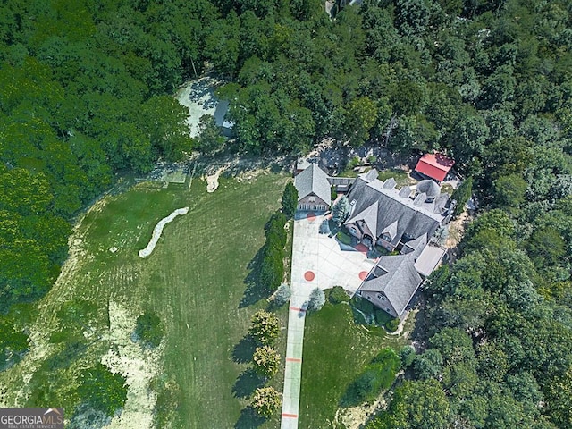 aerial view of property's location featuring a heavily wooded area