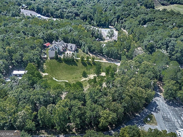 aerial view of property's location with a forest