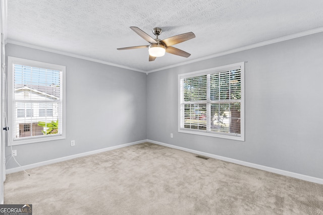 carpeted empty room with a textured ceiling, a healthy amount of sunlight, and ceiling fan